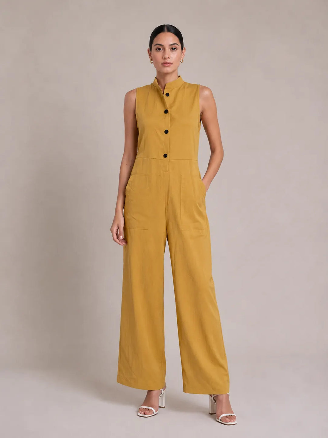 Button-front sleeveless loose-fit jumpsuit with a stand collar